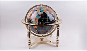 Brass Framed Coloured Globe. Surrounded and mounted on brass frame with a compass on the bottom.