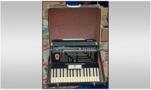 A Cased Accordian, by Gaudini. Model Recanati. With piano keyboard, in a black lacquered case.