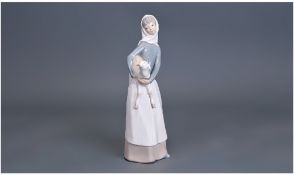 Lladro Figure, of a girl holding a lamb. 11 inches in height.