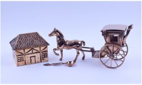 A Brass Figure Of A Horse And Carriage. Together with a brass tea caddy in the shape of a house.