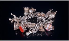 A Good Quality Vintage Silver Bracelet Loaded With 16 Large Charms. All charms with silver marks.