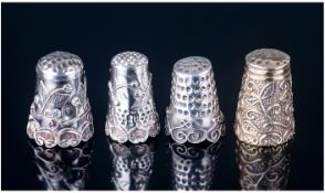 Four Silver Thimbles. Each with Dimpled Tops and Relief Designs To The Exterior. All Test Silver and