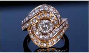 18ct Gold Set Double Crossover Diamond Cluster Ring. The centre brilliant cut oval diamond, est 1.