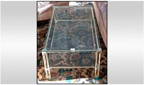 Laquered Brass Framed Coffee Table with two glass shelves. 15 inches high, 36 by 21 inches.