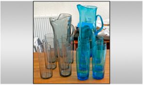 Collection Of Glass Ware. Comprising 2 sets of jugs and six matching glasses. One set in blue and