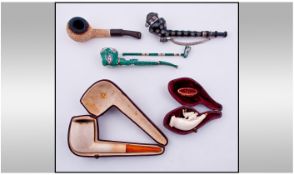 A Collection Of Vienna Made Meerschaum Pipes, 6 in total. Two with leather cases. Various subjects