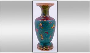 Closionne Vase, 8.5 inches in height. Floral and butterfly decoration on green coloured ground.
