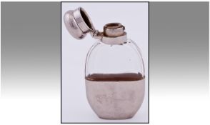 A Small Quality Silver Plated And Glass Hip Flask. Height 4.5 inches.