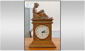 Bronze Coloured Taranis Mantel Clock With Figure Of A Woman Seated Reading A Book To The Top. No