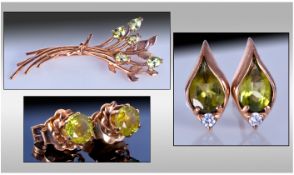 9ct Gold Spray Brooch Set With Peridots In A Flower Setting. With two pairs of matching earrings.