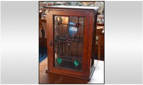 A Leaded Glass Walnut One Door Wall Cabinet. Height 19 inches, 13 inches wide.