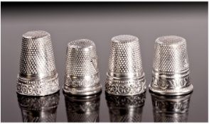 Four Silver Thimbles. All with shield shaped frieze decoration. One marked Germany 925. Two marked