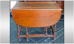 1930's Drop Leaf Table, with barley twist legs and an unusual lift up green baize lined department.
