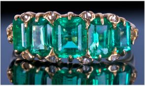 Emerald And Diamond Ring, Set With Five Graduating Emerald Cut Stones Between Rose Cut Diamond