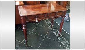 Mahogany Side Table with two drawers on turned legs and castors. C1920's. 30.5 inches high and 36