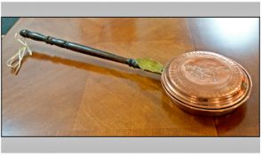 Copper and Brass Warming Pan with wooden handle, etched engraving of a roaring Lion to pan.