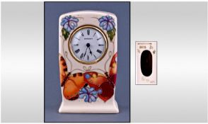 Moorcroft Modern Table Clock. ``Butterfly`` design on cream ground. Date 1993. Height 6 inches,
