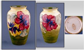 Moorcroft Vase `Hibiscus` Design. On yellow/green ground. Circa 1950`s. Stands 8.25 inches high.