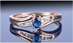 9ct Gold Diamond And Sapphire Ring. Set with a central blue oval sapphire, between 6 Graduated