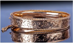 9ct Gold Bangle And Attached Gold Safety Chain. With stylized chased decoration. Fully hallmarked