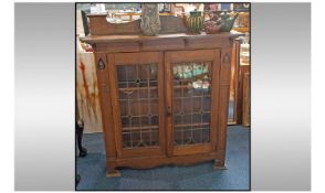 Oak art nouveau leaded glass cabinet Inlayed with art nouveau motifs. Coloured leaded glass design