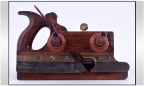 An Antique Wood Plane with brass attachments and fruit wood screw threads.