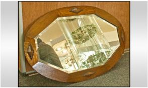 Octagonal Shaped 1930`s Oak Mirror with bevelled glass and applied decoration.