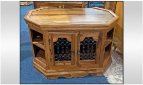 Teak Side Cabinet Of Octagonal Shape. With a pair of cupboards to the centre and wrought iron work.