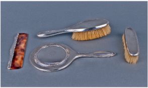 A Matched Silver Cased Four Piece Ladies Dressing Table Set. Consists of hand mirror, hand hair