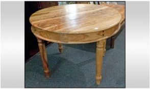 A Round Teak Kitchen Table, on turned legs. 42`` in diameter, 30`` in height.