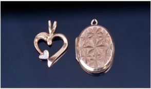 9ct Gold Heart Shaped Pendant. Set with a small diamond chip. Together with an oval 9ct back and