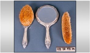 A Vintage - Silver Backed Ladies Three Piece Dressing Set. Comprises Hand Mirror and Brushes.