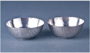 A Pair Of Nigerian Silver Bowls. Decorated in the traditional manner. Marked Ikeana Amadu Kano.