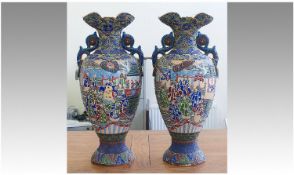 Pair Of Tall Oriental Two Handled Vases. Decorated with oriental figures and oriental designs in