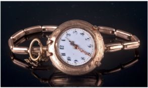 A 14ct Gold Ornate Cased Ladies Fob Watch. Fitted to a gold plated strap. A/F.