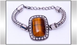 Tiger Eye and Austrian Crystal Bracelet. A large rectangular cabochon tiger eye, framed by a single