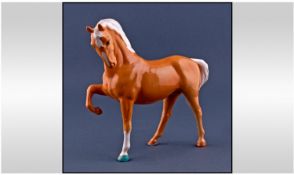 Beswick Horse Figure, Horse Palomino. ``Head tucked, leg up.`` Model 1549. Designer Pal Zalmen.