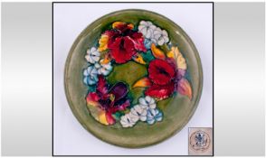 William Moorcroft Signed Shallow Bowl. ``Orchids`` design on green ground. Label to base reads ``