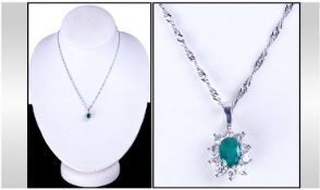 9ct White Gold Set Emerald And Diamond Cluster Pendant. Fitted on a 9ct white gold chain. Estimated