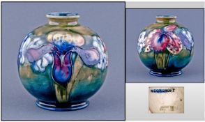 Moorcroft Bulbous Shaped Vase. ``Orchids`` design on green ground. Circa 1940`s. Some grazing, all
