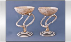 A Pair Of Agate Coloured Glass Bonbon Dishes with spiral configuration stems in the Murano style.