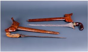 Two Malaysian Kris Daggers, Hilts And Scabbards Made Of Exotic Woods, 19th/20thC Length 18 Inches.