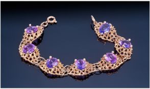 Ladies 9ct Gold Set Amethyst Bracelet. The seven amethysts of good colour. Marked 9ct. 7 inches in