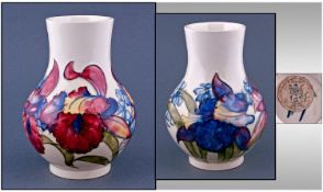 Moorcroft Bulbous Shaped Vase. `Orchids` design on white ground. Label to base reads ``Potters To