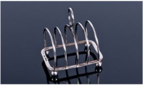 Silver 4 Tier Toast Rack. Raised on four ball feet. Hallmark Sheffield 1924. Height 3 inches, width