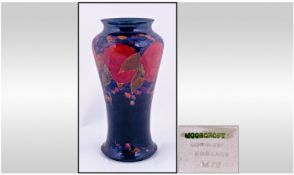 William Moorcroft Signed And Early Impressive Tall Vase. Pomegranate design on blue ground. Circa