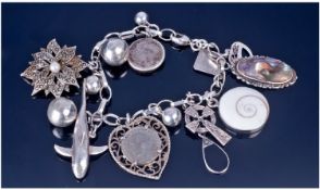 Silver Charm Bracelet Loaded With 14 Various Charms.