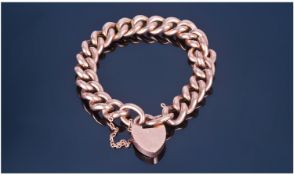 A Good Quality Vintage 9ct Gold Curb Bracelet, with 9ct gold heart shaped padlock. Marked 9ct.