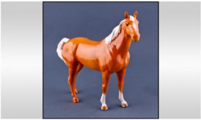 Beswick Horse Figure ``Swish Tail Horse.`` Model number 1182. Palomino gloss. Height 8.75 inches.