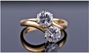 18ct Gold Set Two Stone Diamond Twist Ring. The two brilliant cut diamonds are in a six claw high